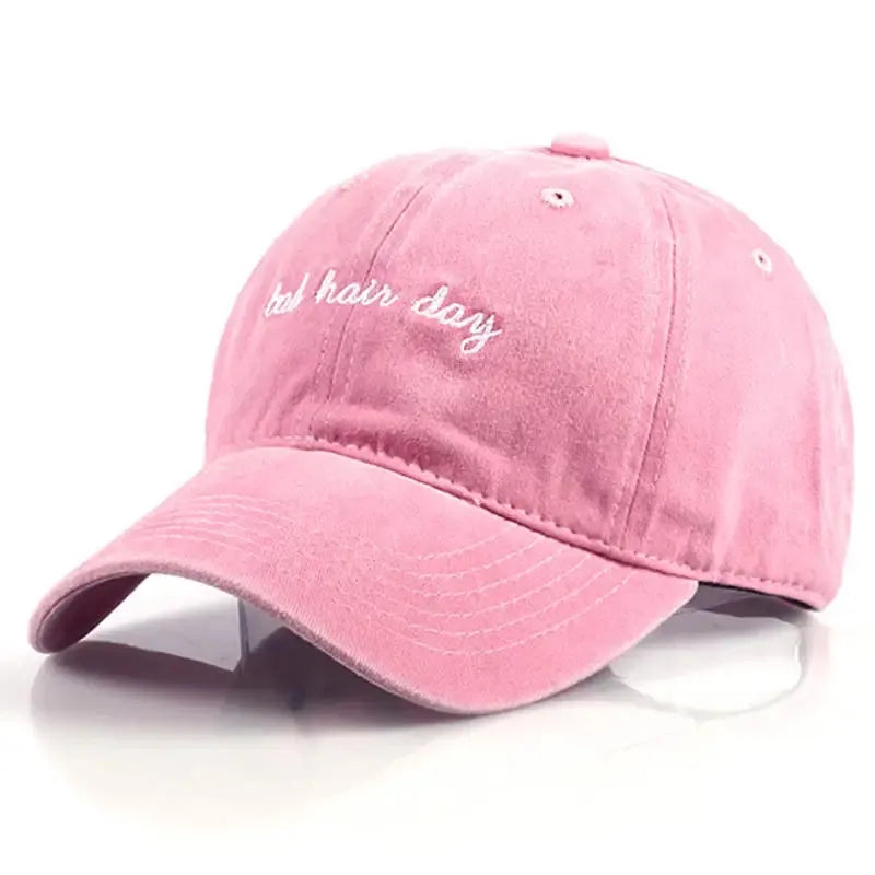 Pink cap, with "bad hair day" embroidered on it