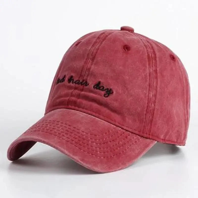 Red cap, with "bad hair day" embroidered on it