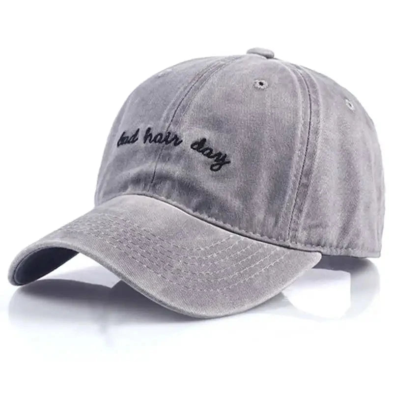Grey cap, with "bad hair day" embroidered on it