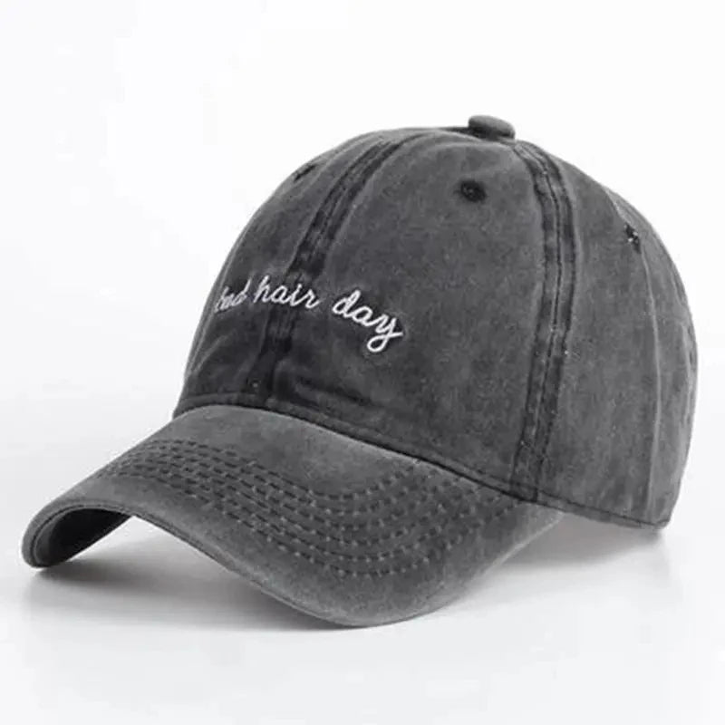 Black cap, with "bad hair day" embroidered on it